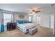 Serene main bedroom with a king-size bed, bench, stylish decor, and natural light at 3237 Mist Effect Ave, Henderson, NV 89044