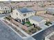 A two-story home boasts a solar panel system and a cozy, walled backyard with synthetic grass and an outdoor dining set at 3237 Mist Effect Ave, Henderson, NV 89044