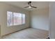 Bright bedroom featuring wood-look floors and a large window providing natural light and backyard views at 3320 Herring Gull Ln, North Las Vegas, NV 89084