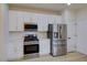 Modern kitchen with stainless steel appliances, sleek white cabinetry, and wood-look flooring for a stylish design at 3320 Herring Gull Ln, North Las Vegas, NV 89084