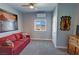 Bedroom with red futon, ceiling fan, and a window offering a view of the landscape at 3341 S Big Sky Way, Pahrump, NV 89048