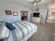 Inviting bedroom showcasing a cozy bed, neutral decor, and an open layout to other rooms at 3341 S Big Sky Way, Pahrump, NV 89048