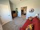 Bedroom featuring a red futon, a wooden dresser, and an adjoining room with a barn door at 3341 S Big Sky Way, Pahrump, NV 89048