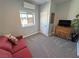 Bedroom featuring a red futon, a wooden dresser, and a window offering an outdoor view at 3341 S Big Sky Way, Pahrump, NV 89048