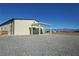 Metal home with a covered patio sitting on a gravel area and beautiful mountain views at 3341 S Big Sky Way, Pahrump, NV 89048