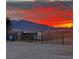 Sunset view of horse property featuring fencing, shelter and striking sky above at 3341 S Big Sky Way, Pahrump, NV 89048