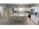 Beautiful kitchen with white cabinetry, granite countertops, stainless steel appliances, and large island with seating at 3341 S Big Sky Way, Pahrump, NV 89048