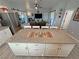 Well-designed kitchen with granite countertops, leading to the living area, bedrooms, laundry, and pantry at 3341 S Big Sky Way, Pahrump, NV 89048