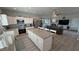 Spacious kitchen overlooking the living area, featuring a large center island with seating and stainless appliances at 3341 S Big Sky Way, Pahrump, NV 89048