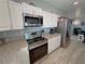 Modern kitchen featuring stainless steel appliances, granite countertops, and white cabinetry at 3341 S Big Sky Way, Pahrump, NV 89048