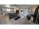 Open-concept living room with barn doors, neutral decor, and modern furniture on stylish hard surface floors at 3341 S Big Sky Way, Pahrump, NV 89048