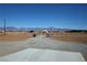Gravel driveway leading into the property with views of the mountains in the distance at 3341 S Big Sky Way, Pahrump, NV 89048