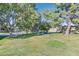 Expansive community park with lush green lawn and mature trees, offering a serene and inviting outdoor space for residents at 3753 Heritage Ave, Las Vegas, NV 89121