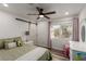 Cozy bedroom with hardwood floors, barn-style door, neutral walls, and a well-lit window at 4401 Lilac Glen Dr, Las Vegas, NV 89129