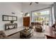 Bright, airy living room featuring tile floors, large windows, and comfortable seating area at 4401 Lilac Glen Dr, Las Vegas, NV 89129