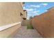A narrow backyard featuring a brick wall and partial artifical turf at 4625 Ridgeley Ave # 103, North Las Vegas, NV 89084