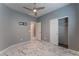A cozy bedroom offers marble floors, a ceiling fan, pre-installed TV mount, and a closet with an open door at 4625 Ridgeley Ave # 103, North Las Vegas, NV 89084