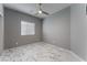 Bedroom with white marble floors, gray walls, ceiling fan, and a window providing natural light at 4625 Ridgeley Ave # 103, North Las Vegas, NV 89084