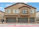 Beautiful two-story home featuring a three-car garage, balcony, and manicured landscaping at 4625 Ridgeley Ave # 103, North Las Vegas, NV 89084
