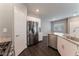 Well-lit kitchen featuring stainless steel appliances, granite countertops, and modern white cabinets at 4625 Ridgeley Ave # 103, North Las Vegas, NV 89084