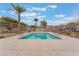 Community pool surrounded by metal fence and palm trees at 4625 Ridgeley Ave # 103, North Las Vegas, NV 89084