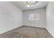 Neutral bedroom featuring carpeted floors, white walls, and a window at 4730 E Craig Rd # 1093, Las Vegas, NV 89115