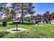 Community area offering BBQ grills, a grassy lawn, playground, and mature trees at 4730 E Craig Rd # 1093, Las Vegas, NV 89115