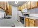 Galley kitchen with neutral countertop, cabinetry, standard appliances and double basin sink at 4730 E Craig Rd # 1093, Las Vegas, NV 89115