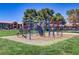 Community playground with colorful play structure set on a grassy lawn at 4730 E Craig Rd # 1093, Las Vegas, NV 89115
