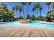 Relaxing community pool surrounded by mature palm trees and comfortable lounge chairs at 4730 E Craig Rd # 1093, Las Vegas, NV 89115
