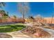 Manicured backyard featuring mature landscaping, rock features, and inviting walkways at 4775 N Grand Canyon Dr, Las Vegas, NV 89129