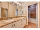 Bright bathroom featuring a double sink vanity with marble countertops and traditional fixtures at 4775 N Grand Canyon Dr, Las Vegas, NV 89129