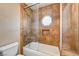 Stylish bathroom features a tub and shower combination with attractive tile work and a unique octagonal window at 4775 N Grand Canyon Dr, Las Vegas, NV 89129