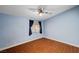 Comfortable bedroom featuring tile flooring, a ceiling fan, and a window offering natural light with outside views at 4775 N Grand Canyon Dr, Las Vegas, NV 89129