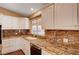 A kitchen view of the granite counters, a stainless steel dishwasher, and custom cabinets at 4775 N Grand Canyon Dr, Las Vegas, NV 89129