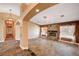Spacious living room featuring a stone fireplace and tile flooring at 4775 N Grand Canyon Dr, Las Vegas, NV 89129