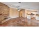 A living room view to the kitchen and stone fireplace at 4775 N Grand Canyon Dr, Las Vegas, NV 89129