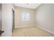 Well-lit bedroom with neutral carpet, plantation shutters, and a closet at 4900 Cascade Pools Ave, Las Vegas, NV 89131