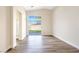 Bright bedroom featuring wood floors and sliding glass doors to the backyard at 4900 Cascade Pools Ave, Las Vegas, NV 89131