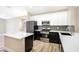 Well-equipped kitchen with stainless steel appliances and sleek black and white cabinetry at 4900 Cascade Pools Ave, Las Vegas, NV 89131
