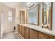 Bathroom featuring wood vanity and an array of mirrors, enhancing the room's brightness at 518 Topaz Ave, Henderson, NV 89015