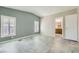 Inviting bedroom with large windows, vaulted ceiling, and open doorway to bathroom at 518 Topaz Ave, Henderson, NV 89015