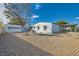 A cozy single-story home boasts a low-maintenance gravel yard and covered parking, blending functionality with simple charm at 518 Topaz Ave, Henderson, NV 89015