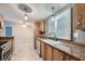 Well-lit kitchen featuring wood cabinets, granite countertops, and stainless-steel appliances at 518 Topaz Ave, Henderson, NV 89015