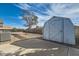 Backyard shed with concrete patio and gravel landscaping at 518 Topaz Ave, Henderson, NV 89015