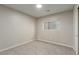 A carpeted bedroom with natural light from a window that has neutral colored walls and a closet at 5317 Welch Valley Ave, Las Vegas, NV 89131