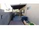 Covered back patio featuring an AC unit, concrete, brick and a white dog at 5856 Sutcliffe Cir, Las Vegas, NV 89110