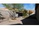 Beautifully paved backyard with a mature tree and an outdoor kitchen under a pergola at 5856 Sutcliffe Cir, Las Vegas, NV 89110