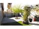 Spacious backyard with brick paving, artificial grass, mature trees, and pergola with outdoor grill at 5856 Sutcliffe Cir, Las Vegas, NV 89110