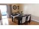 Elegant dining room with a dark wood table, seating for four, and slider door at 5856 Sutcliffe Cir, Las Vegas, NV 89110